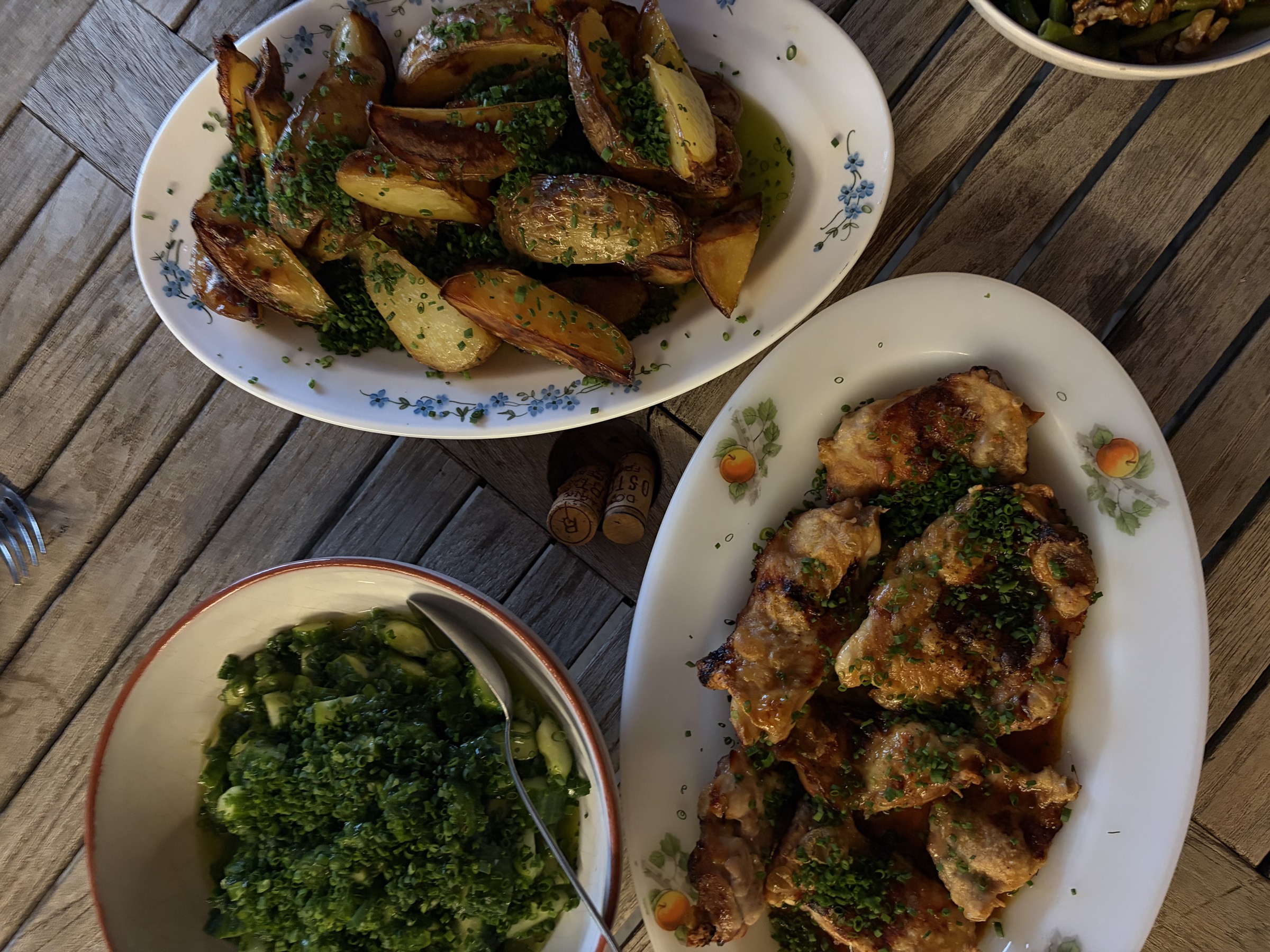 An overhead spread of chicken, roast potatoes and cucumber salad for the team